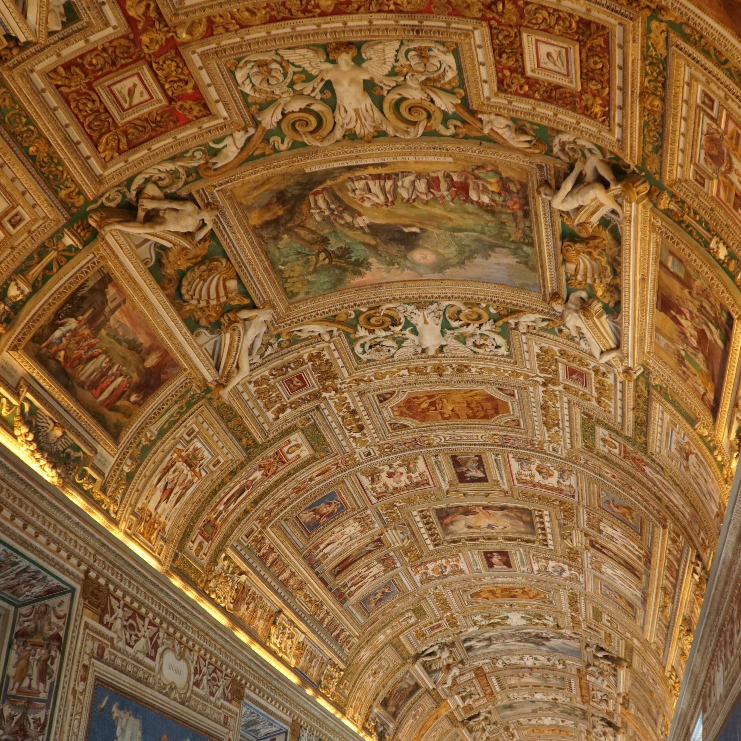 destination italy 2 ornate vaulted ceiling with intricate frescoes and gilded details depicting figures and scenes. the richly decorated architecture features vibrant colors and elaborate patterns.